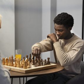 men-playing-chess-indoors-side-view