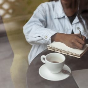 unrecognisable-afroamerican-woman-writing